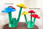 Two colorful flower bouquets made of interlocking bricks on a wooden surface.