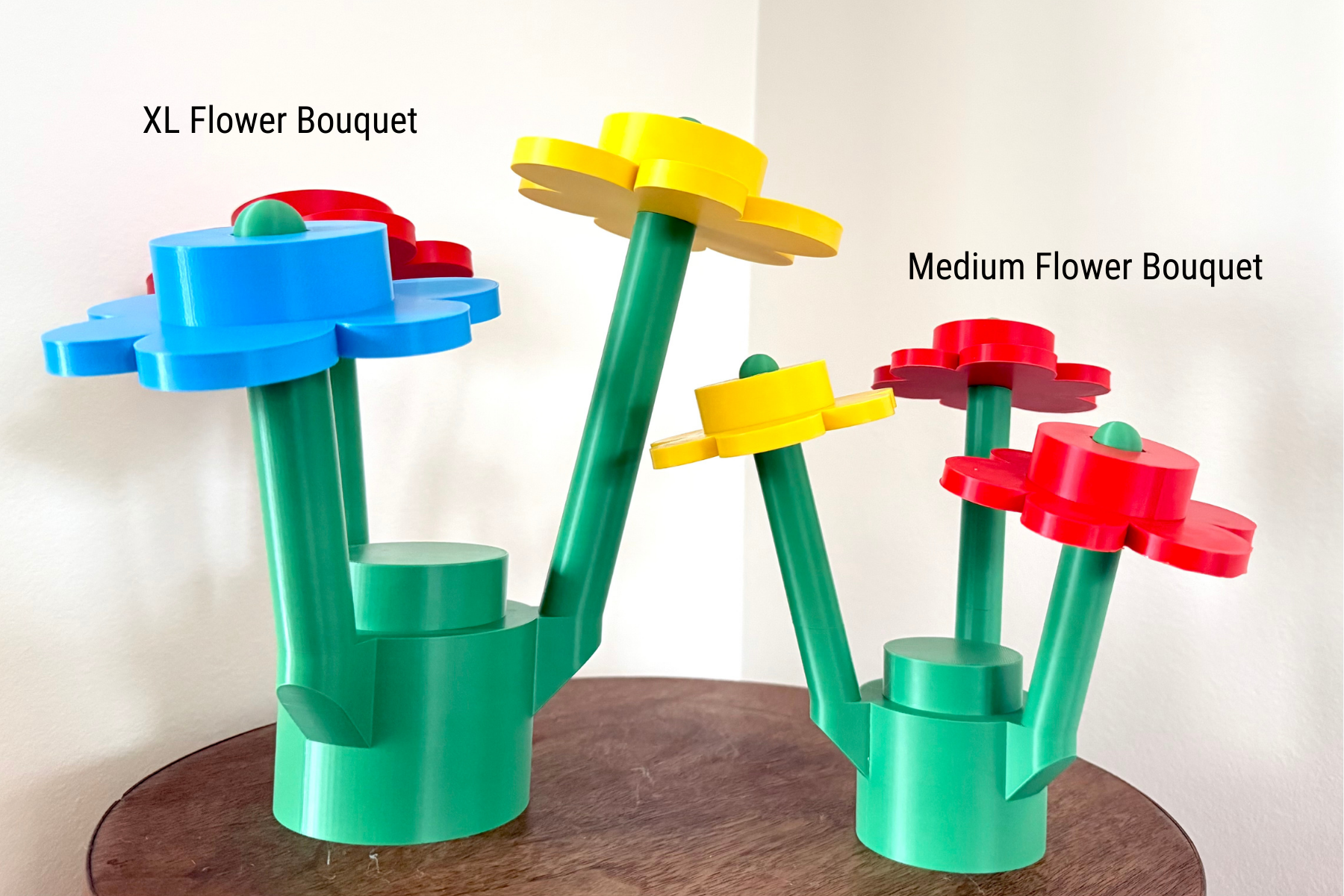 Two colorful flower bouquets made of interlocking bricks on a wooden surface.
