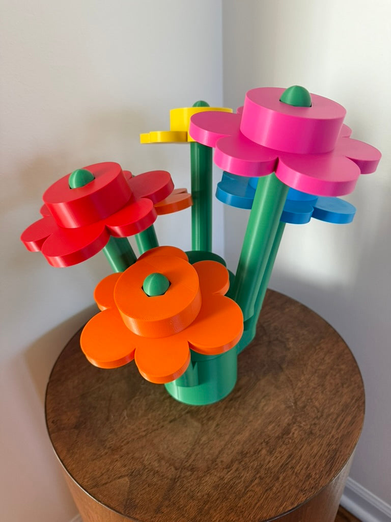Colorful flower-shaped building blocks on a wooden surface with a white wall background