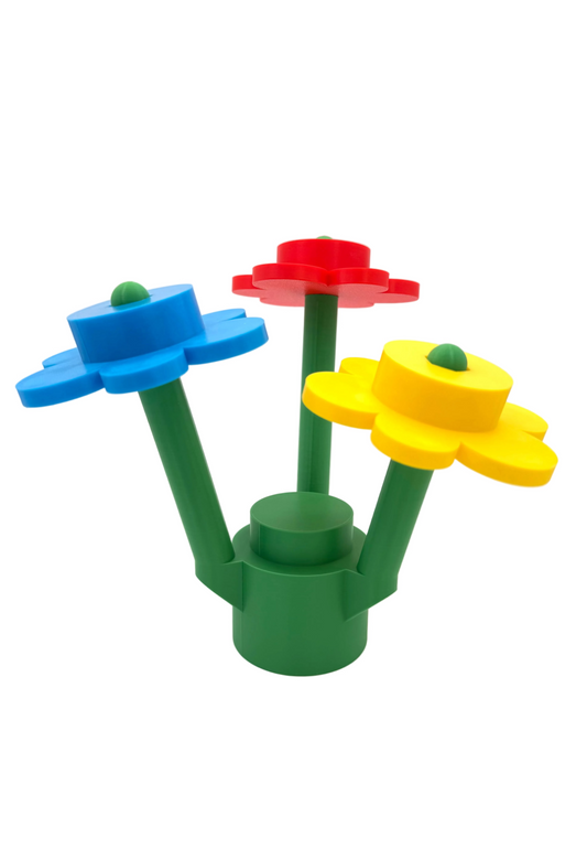 Colorful toy flowers made of interlocking bricks on a white background