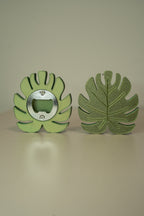 Green leaf-shaped bottle opener on a beige background