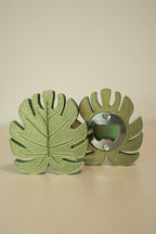 Green leaf-shaped bottle opener on a beige background
