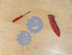 Two plastic circular measuring tools with measurements on a wooden surface