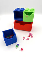 Colorful storage cubes with small items on a white background