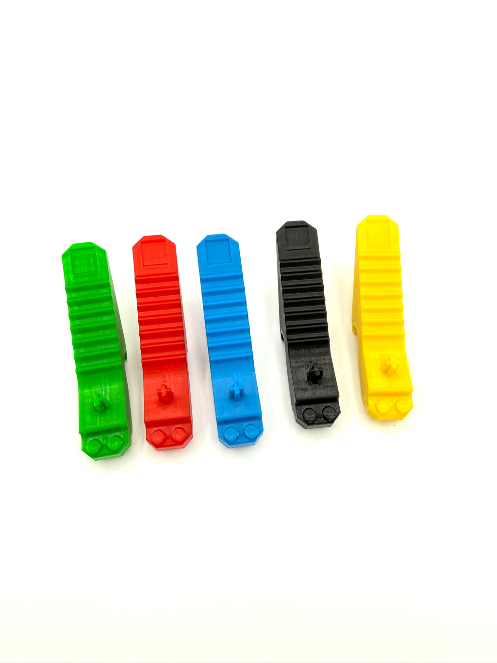 Five colorful plastic LEGO bottle openers on a white background