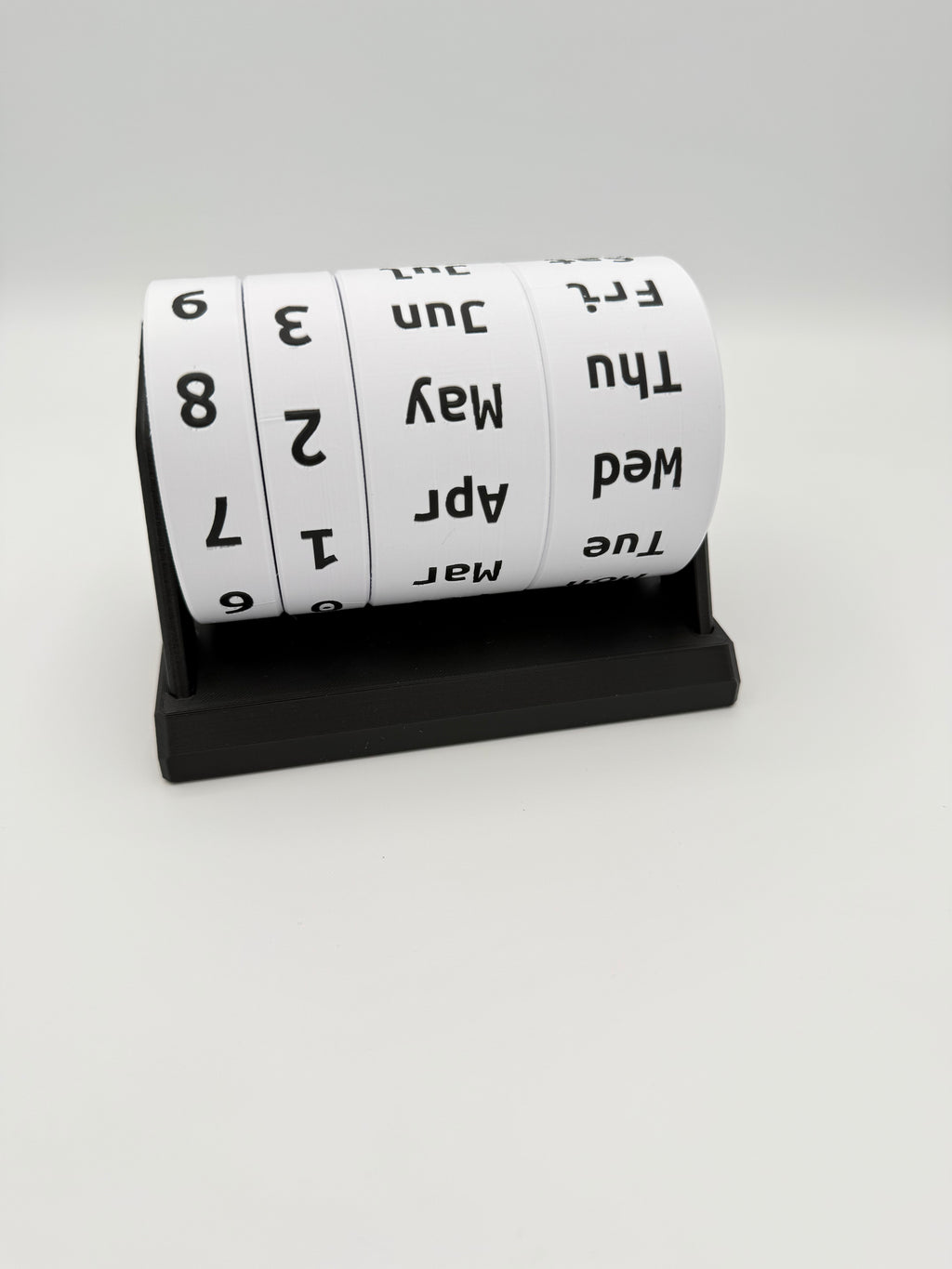 Roll of calendar tape with black text on a white background