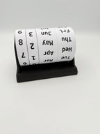 Roll of calendar tape with black text on a white background