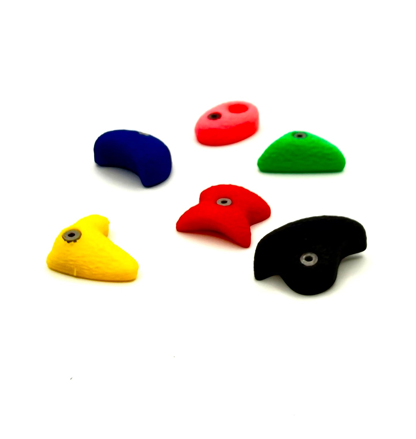 Set of colorful plastic rock bouldering magnets on a white background