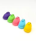 Five colorful plastic ducks in different colors on a white background