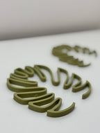 Green 3D-printed letters on a white surface